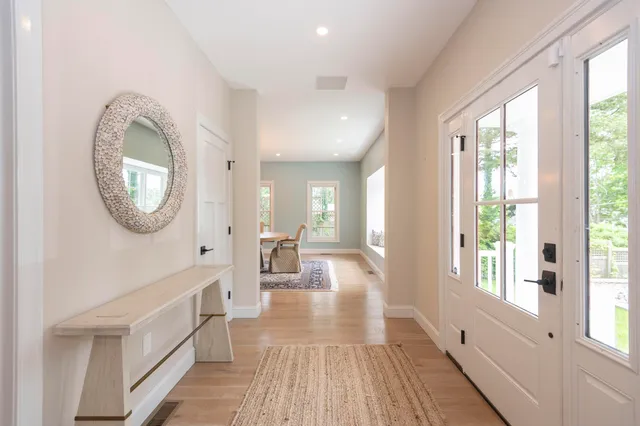 a view of a room with wooden floor and windows