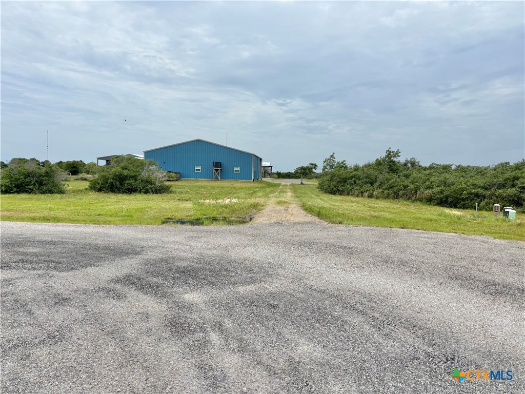 9 Boca Grande Loop Port O'Connor, TX 77982 - Photo 40 of 44 a view of a big room with a big yard and large trees