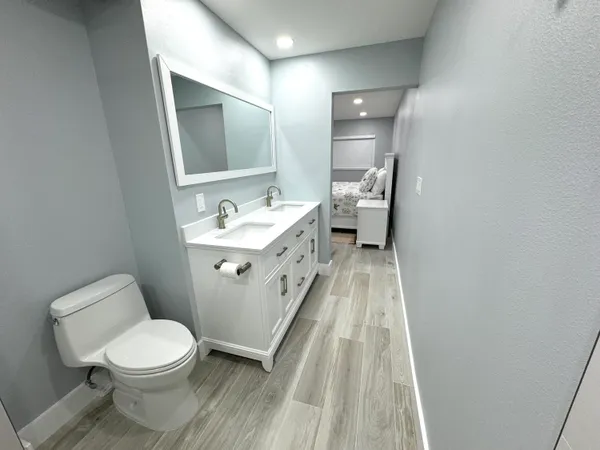 a bathroom with a sink a toilet and mirror