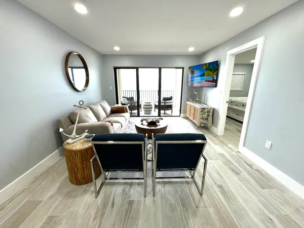 a dining room with furniture and a wooden floor