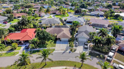 an aerial view of residential houses with outdoor space and street view