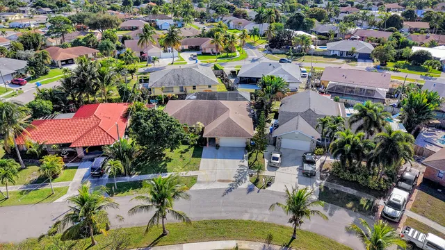 an aerial view of residential houses with outdoor space and street view