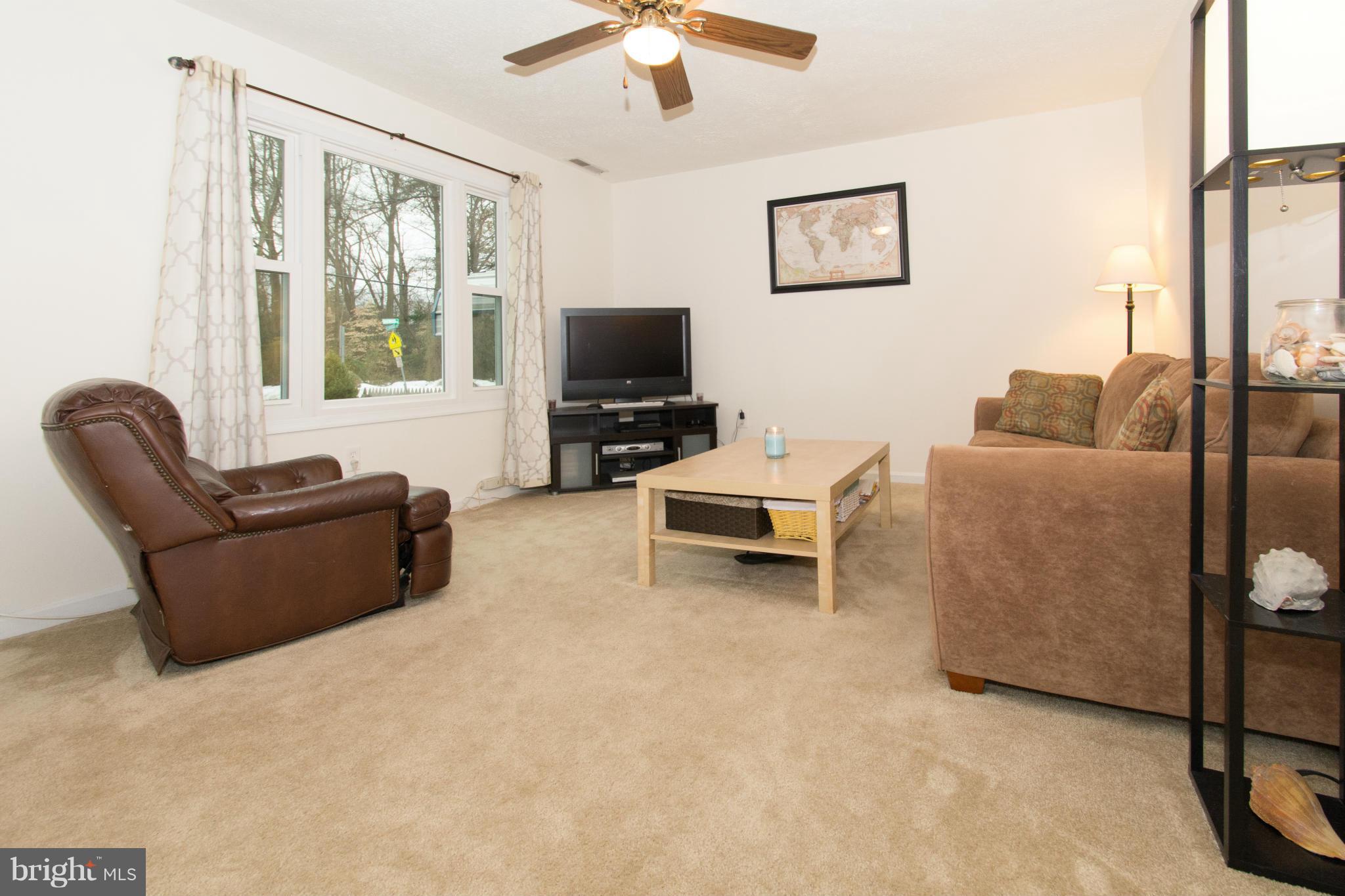110 Oakwood Road Edgewater, MD 21037 - Photo 2 of 23 a living room with furniture and a flat screen tv