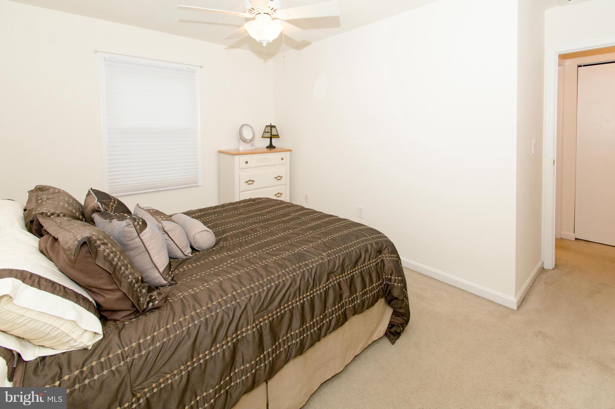 110 Oakwood Road Edgewater, MD 21037 - Photo 18 of 23 a bedroom with a bed and a chandelier