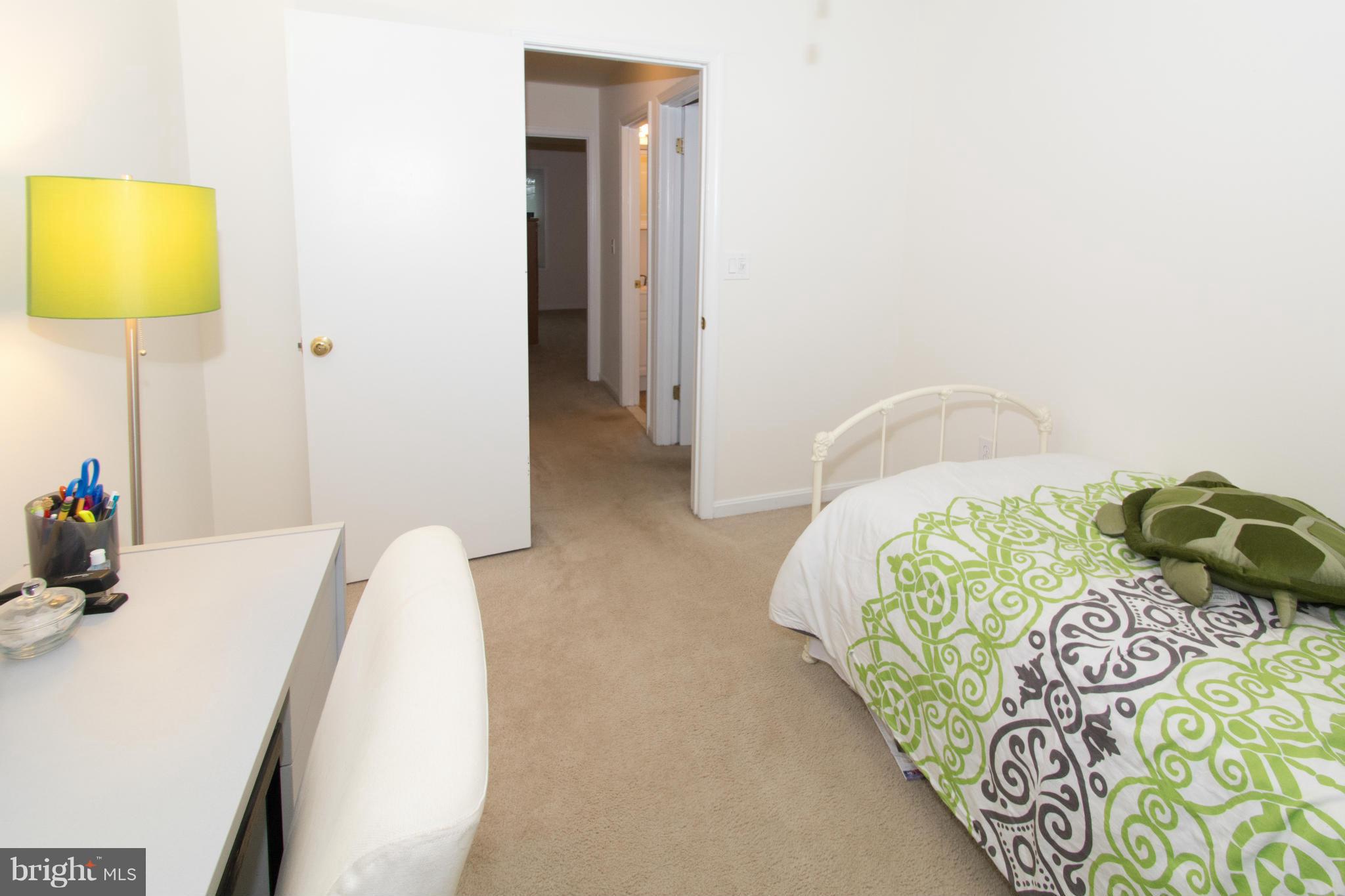 110 Oakwood Road Edgewater, MD 21037 - Photo 21 of 23 a bedroom with a bed and a lamp