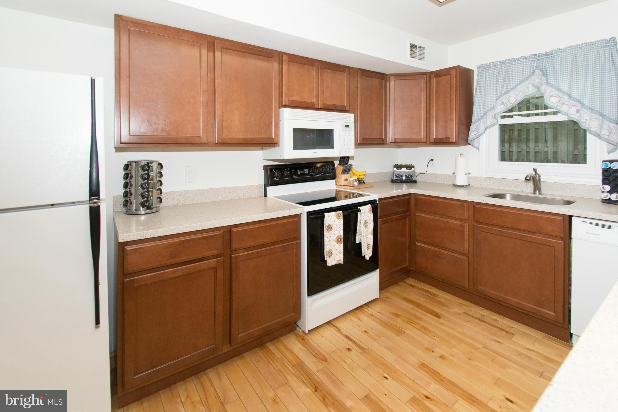 110 Oakwood Road Edgewater, MD 21037 - Photo 5 of 23 a kitchen with stainless steel appliances granite countertop a sink stove and microwave