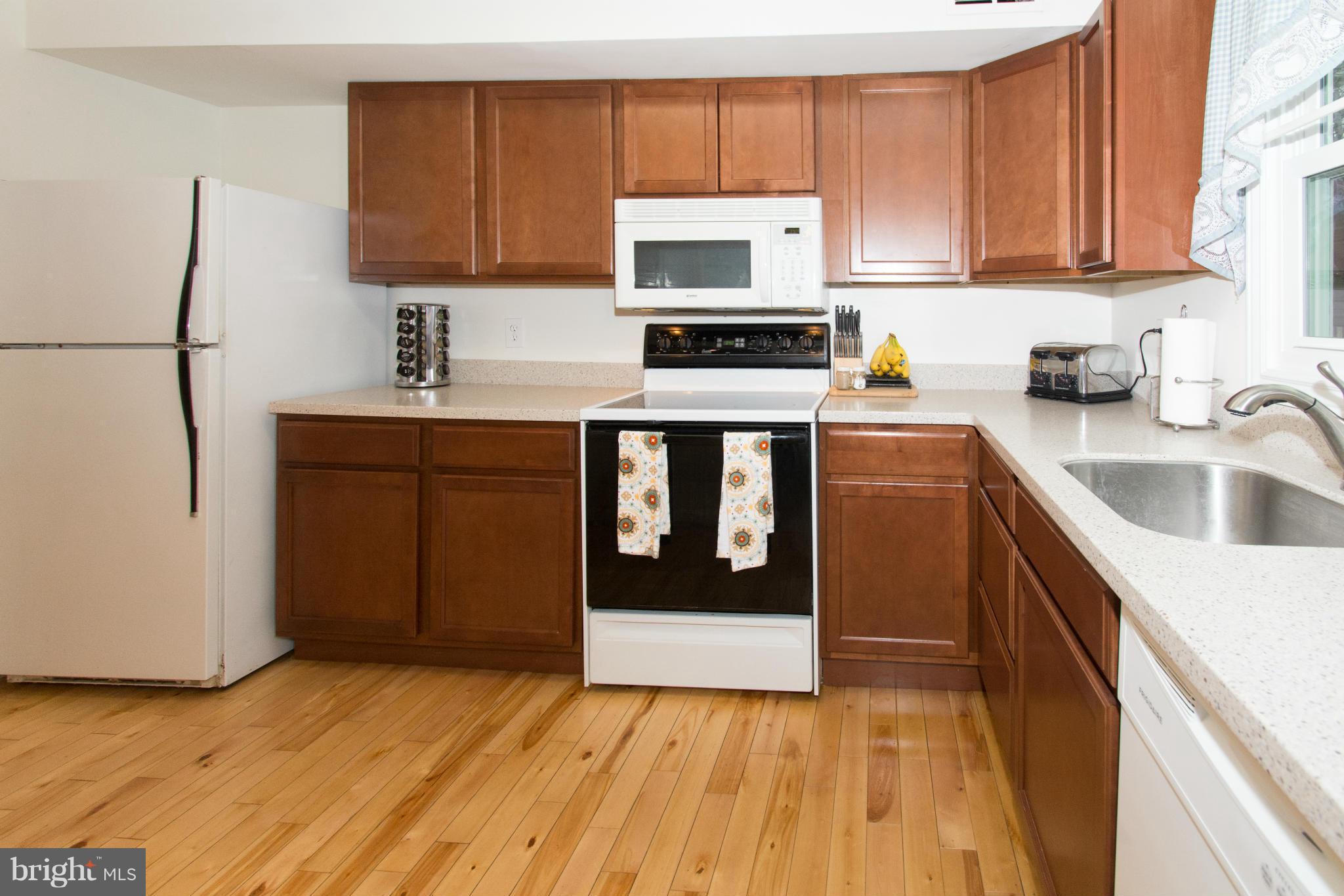 110 Oakwood Road Edgewater, MD 21037 - Photo 6 of 23 a kitchen with a sink stove and cabinets