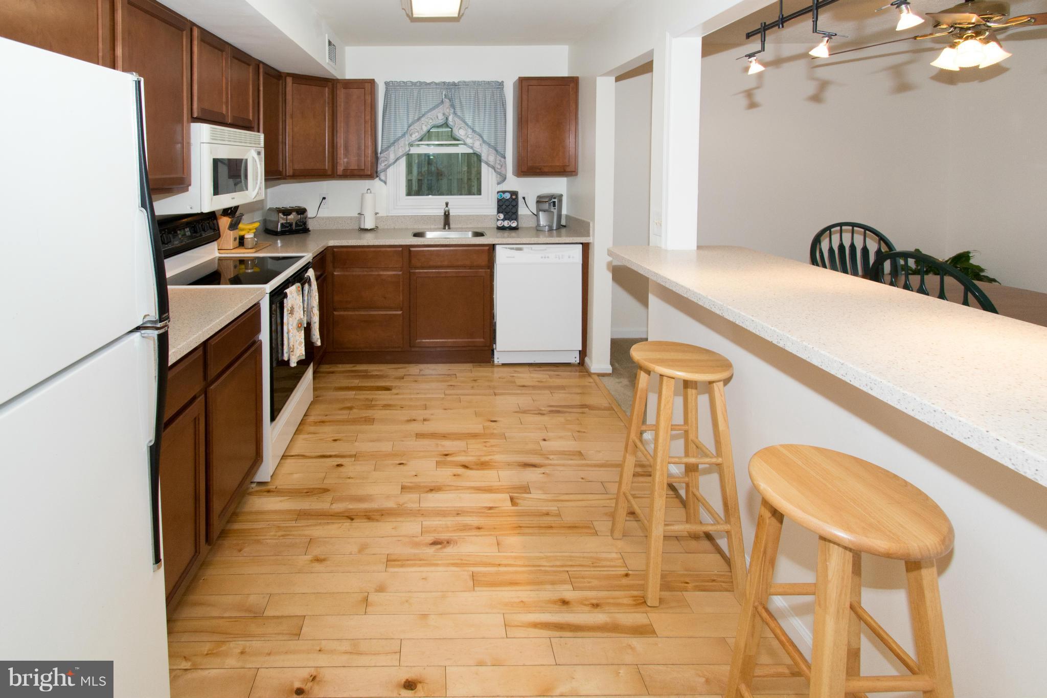 110 Oakwood Road Edgewater, MD 21037 - Photo 7 of 23 a kitchen with a sink a stove top oven and cabinetry