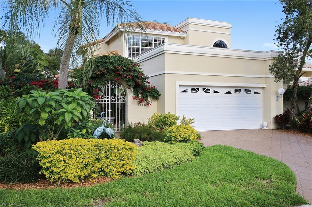 211 Via Napoli Naples, FL 34105 - Photo 1 of 23 a front view of a house with a yard