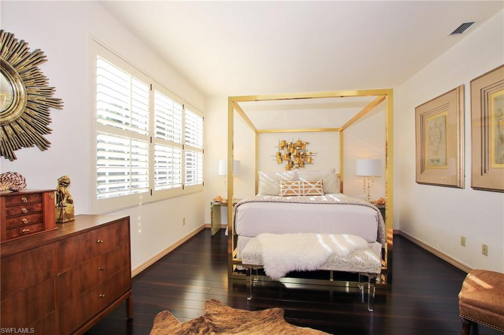 211 Via Napoli Naples, FL 34105 - Photo 11 of 23 a bed room with a bed and a window