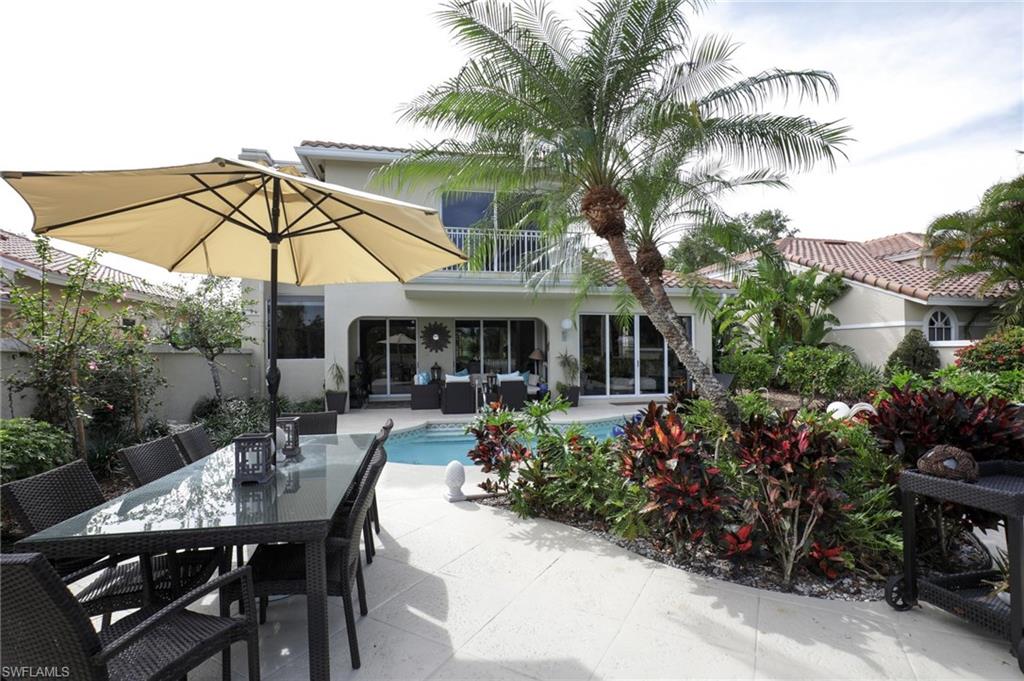 211 Via Napoli Naples, FL 34105 - Photo 16 of 23 a view of a house with backyard and sitting area