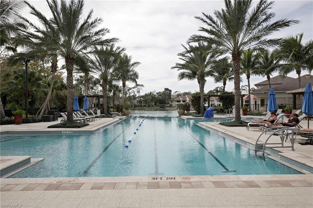 211 Via Napoli Naples, FL 34105 - Photo 17 of 23 a view of a swimming pool with lounge chair