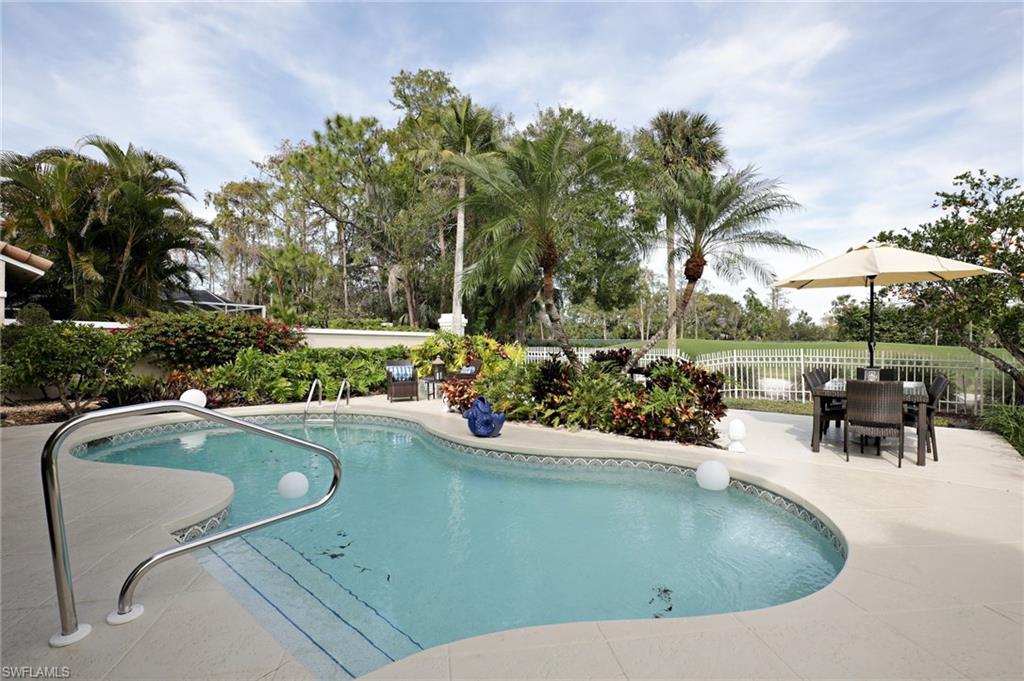 211 Via Napoli Naples, FL 34105 - Photo 19 of 23 a view of a swimming pool and a yard