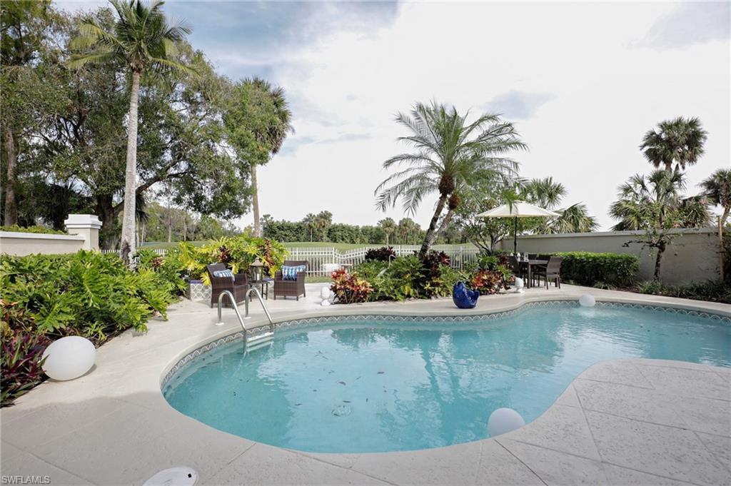 211 Via Napoli Naples, FL 34105 - Photo 20 of 23 a view of a backyard patio and swimming pool