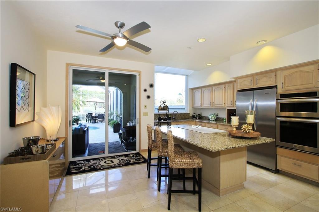 211 Via Napoli Naples, FL 34105 - Photo 5 of 23 a kitchen with a center island appliances and cabinets