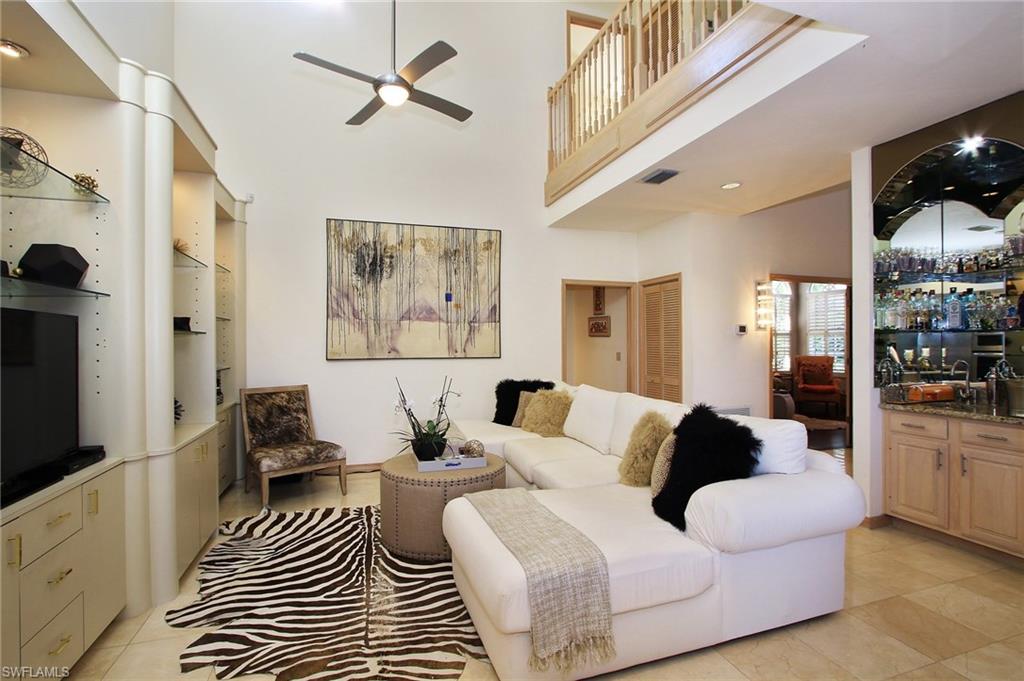 211 Via Napoli Naples, FL 34105 - Photo 7 of 23 a living room with furniture and a flat screen tv