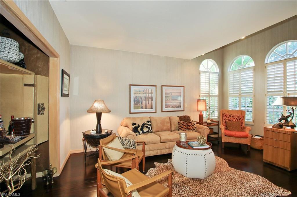 211 Via Napoli Naples, FL 34105 - Photo 8 of 23 a living room with furniture and a flat screen tv