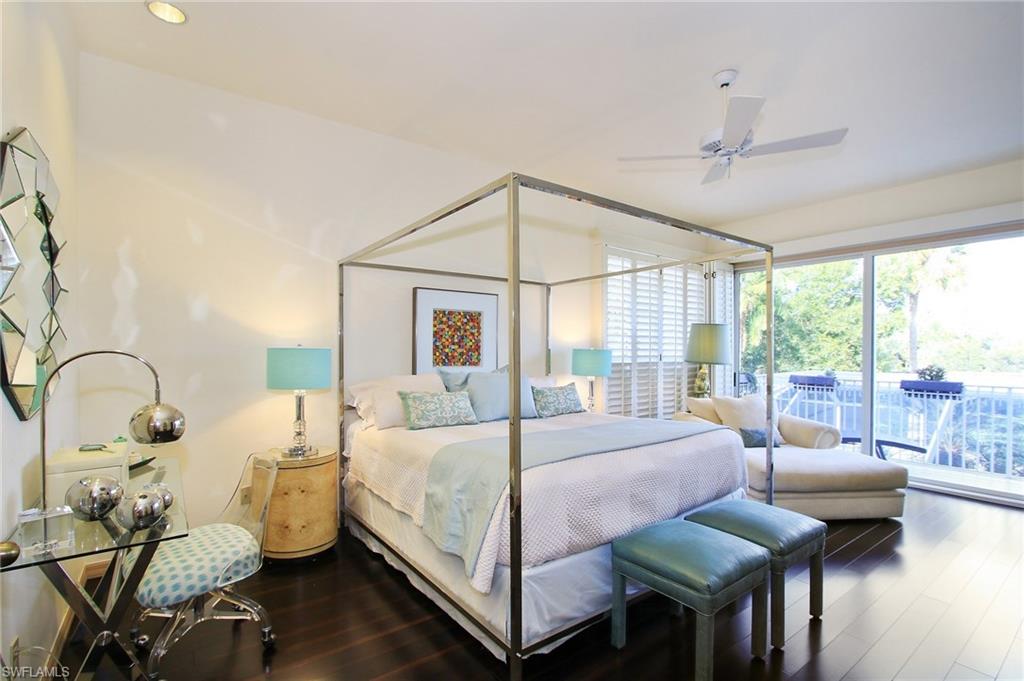 211 Via Napoli Naples, FL 34105 - Photo 9 of 23 a bedroom with a bed and large windows