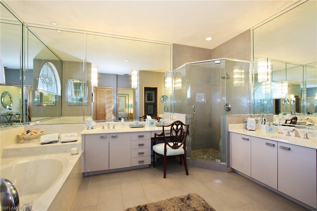 211 Via Napoli Naples, FL 34105 - Photo 10 of 23 a large bathroom with a large tub and sink