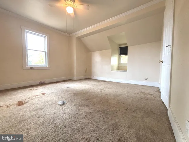 an empty room with a empty space and windows