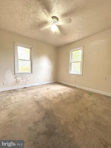 an empty room with windows and closet