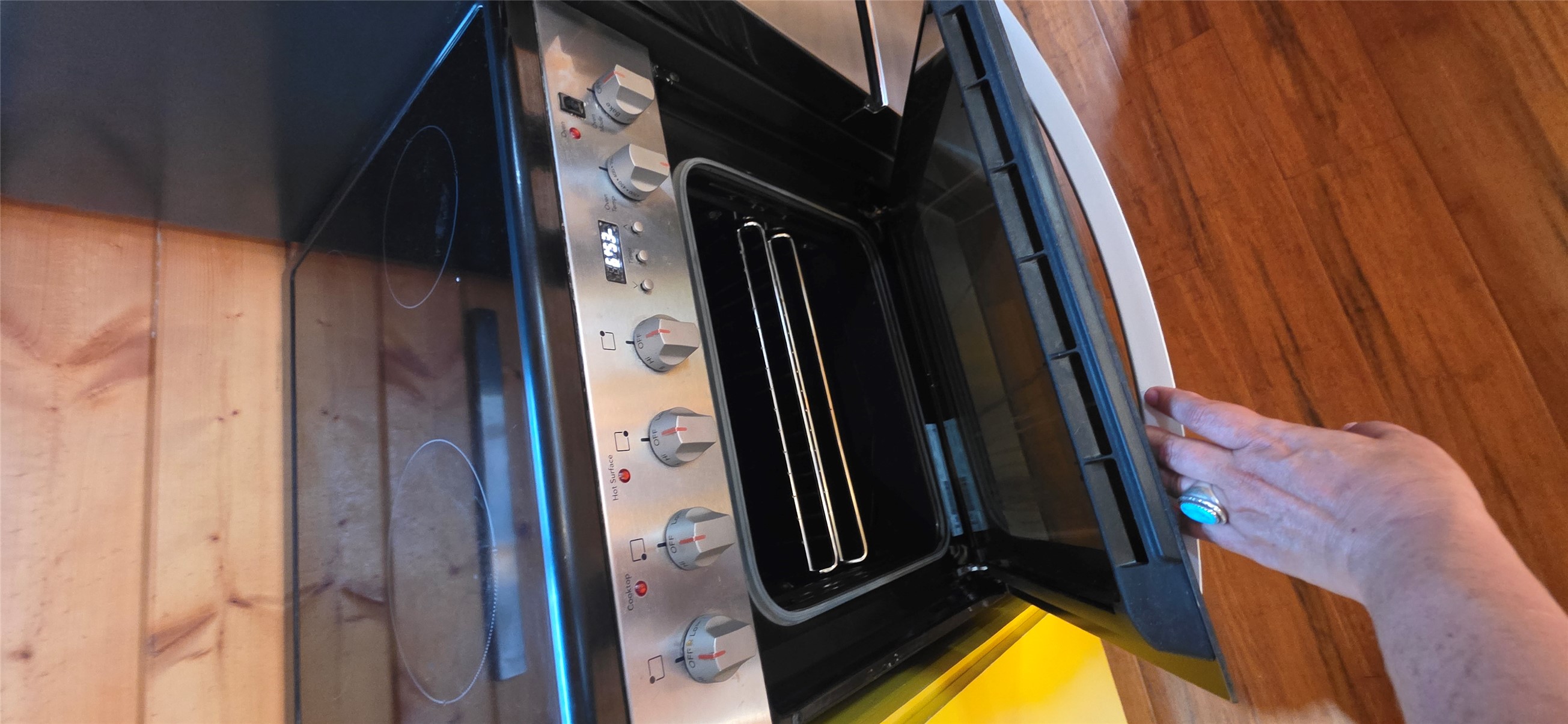 916 South Main Street Lockhart, TX 78644 - Photo 15 of 18 An electric range with a sleek black cooktop and stainless steel controls offers modern culinary convenience.