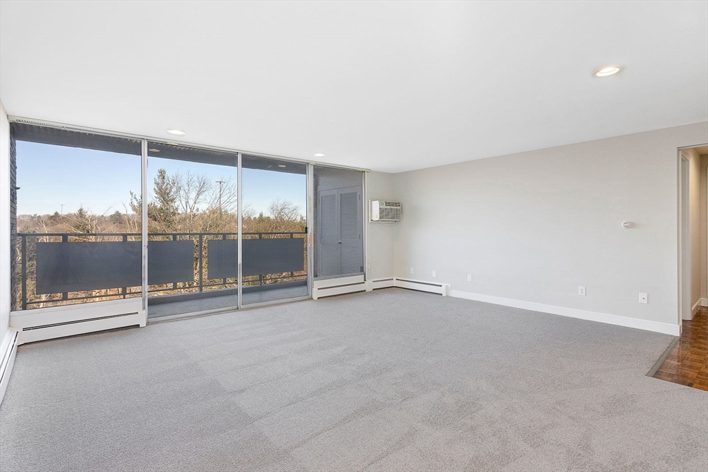 an empty room with sliding glass door and outdoor space