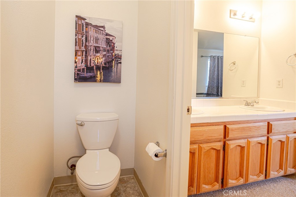 30142 Revis Road Coarsegold, CA 93614 - Photo 24 of 43 a bathroom with a toilet a sink and mirror