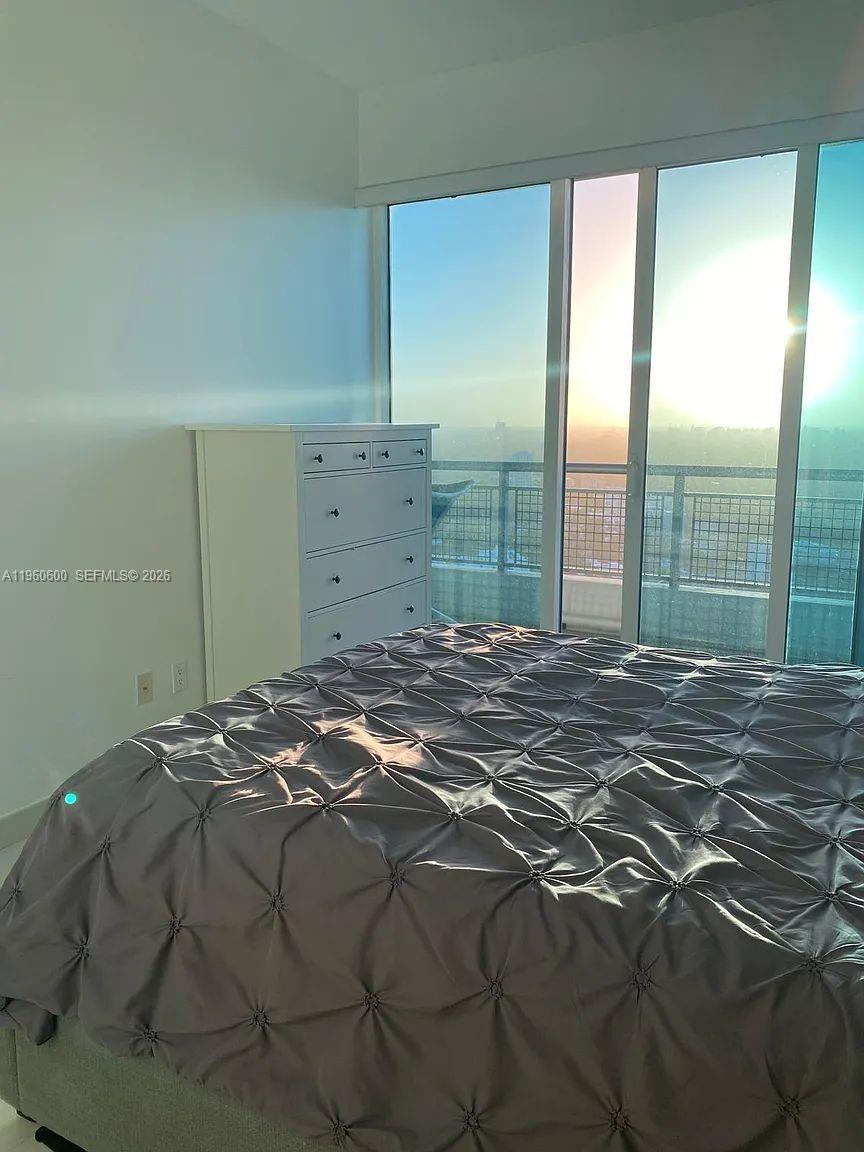 60 Southwest 13th Street, Unit 3405 Miami, FL 33130 - Photo 11 of 17 a bedroom with a bed and a window