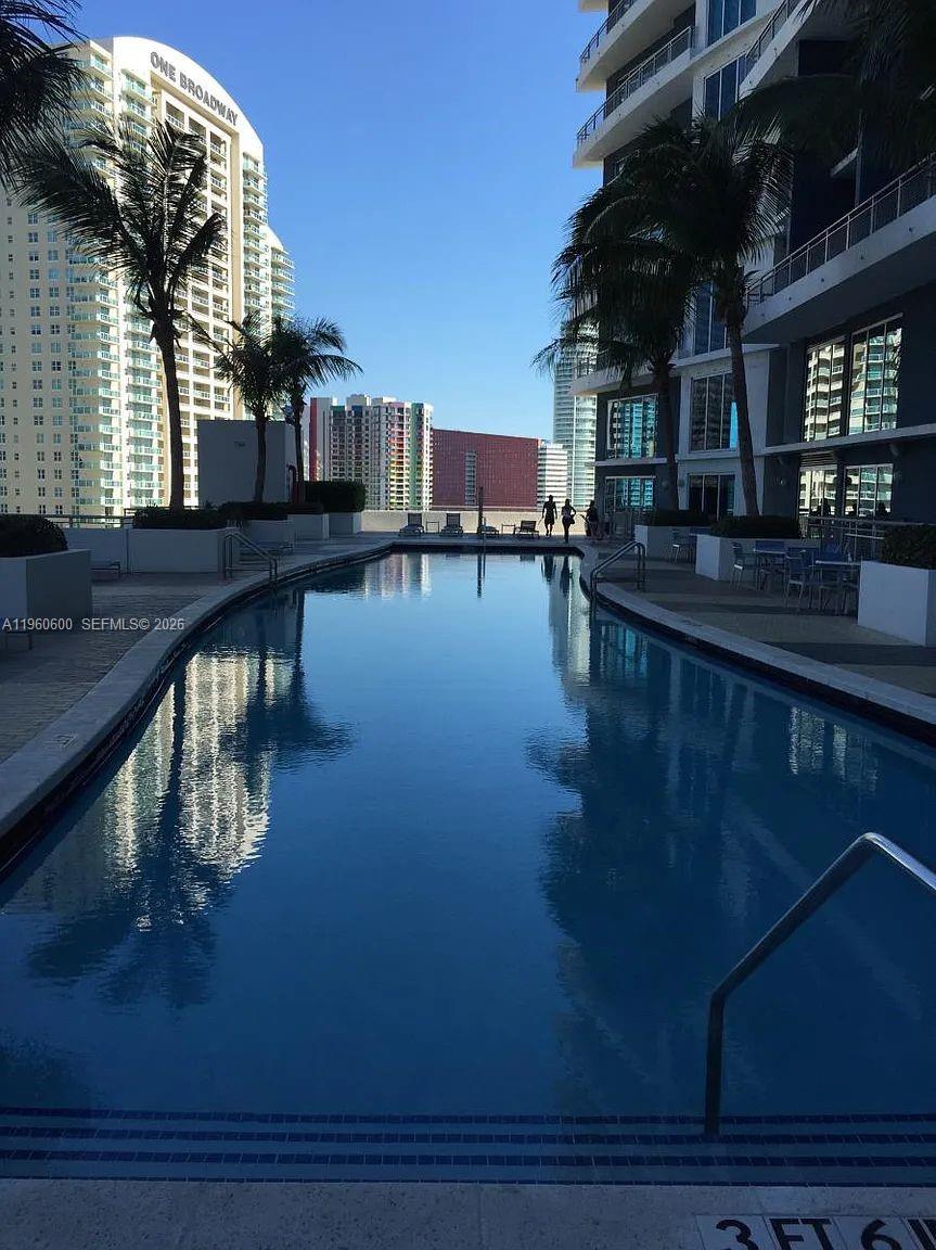 60 Southwest 13th Street, Unit 3405 Miami, FL 33130 - Photo 15 of 17 a view of balcony with dining table and chairs