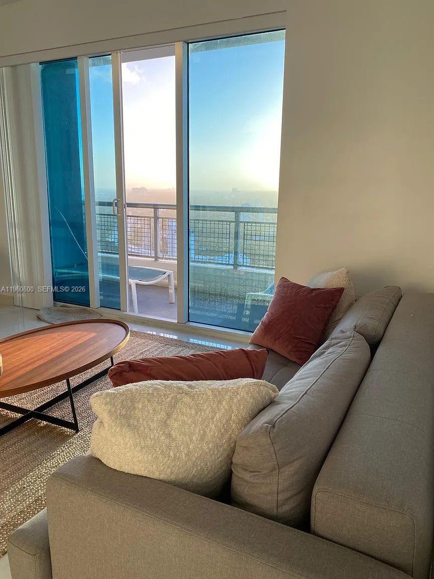 60 Southwest 13th Street, Unit 3405 Miami, FL 33130 - Photo 4 of 17 a living room with furniture and a window