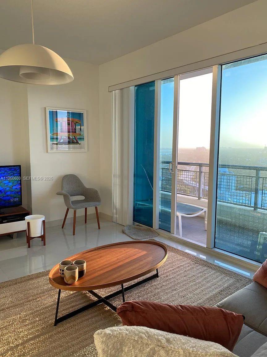 60 Southwest 13th Street, Unit 3405 Miami, FL 33130 - Photo 5 of 17 a bedroom with a bed and glass door