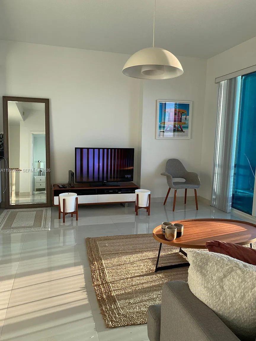 60 Southwest 13th Street, Unit 3405 Miami, FL 33130 - Photo 6 of 17 a living room with furniture and a table