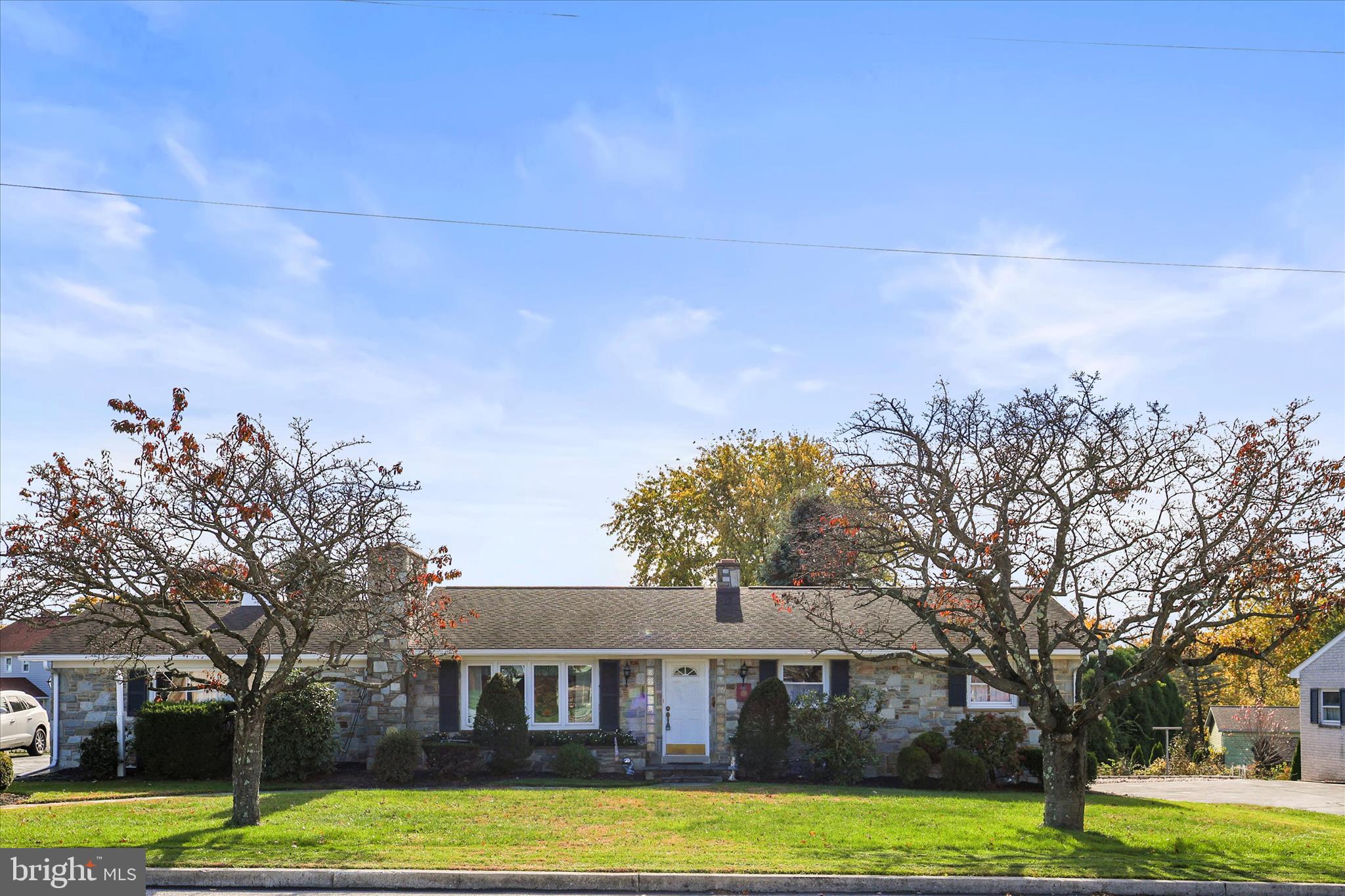 a view of a house with garden and trees