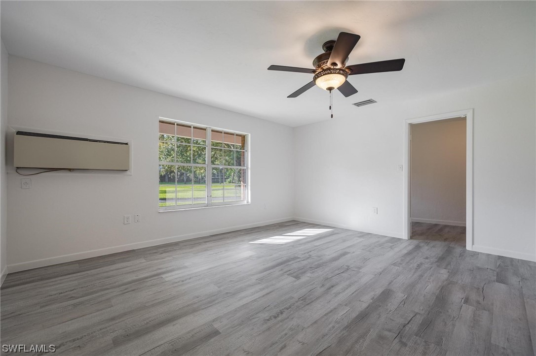 1850 Fort Denaud Road LaBelle, FL 33935 - Photo 18 of 37 a view of empty room with wooden floor and fan