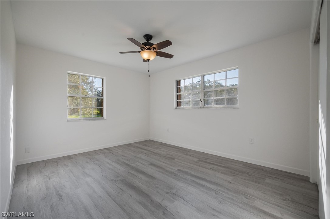 1850 Fort Denaud Road LaBelle, FL 33935 - Photo 22 of 37 a view of an empty room with wooden floor and a window