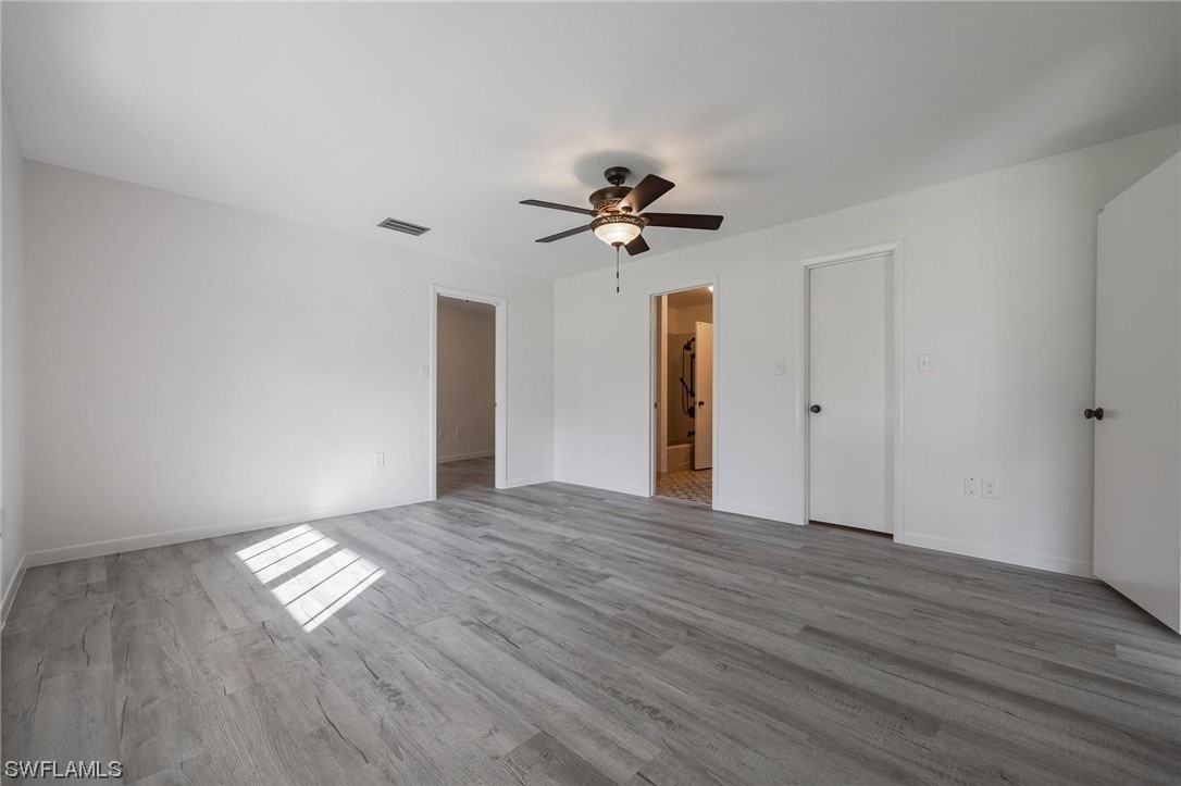 1850 Fort Denaud Road LaBelle, FL 33935 - Photo 23 of 37 a view of empty room with wooden floor and fan