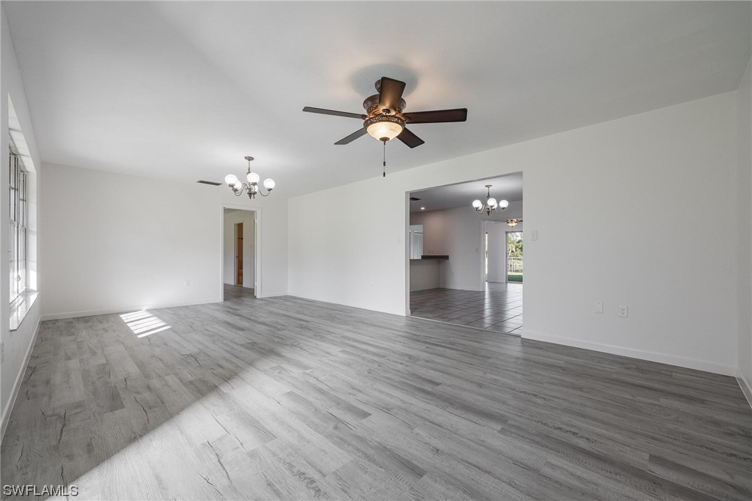 1850 Fort Denaud Road LaBelle, FL 33935 - Photo 8 of 37 wooden floor in an empty room with a window