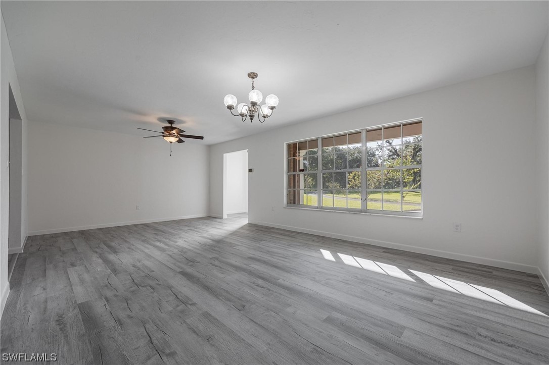 1850 Fort Denaud Road LaBelle, FL 33935 - Photo 9 of 37 a view of empty room with wooden floor and fan