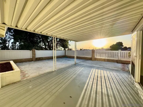 a view of a patio with wooden floor