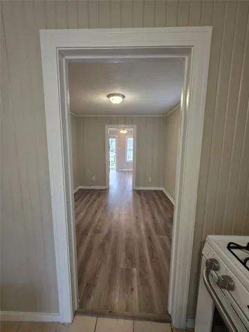 a view of a hallway with wooden floor