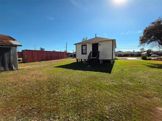 a view of a back yard of the house with a yard