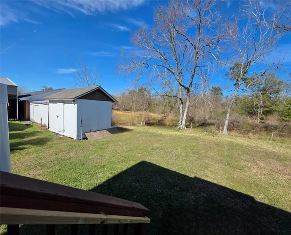 a view of a backyard with large trees