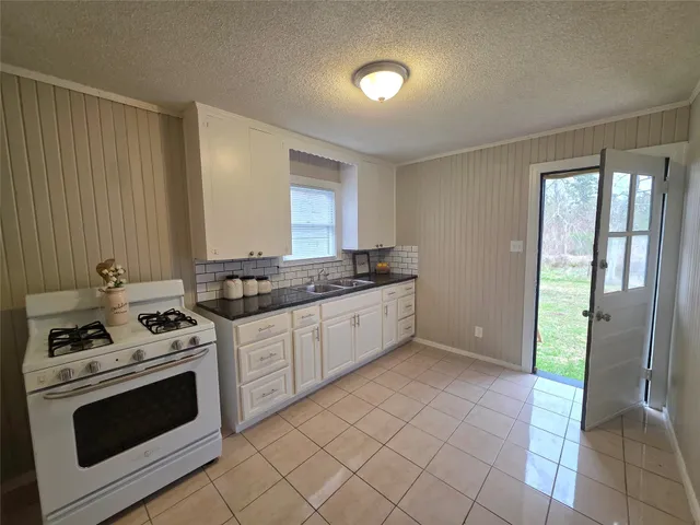 a kitchen with a stove and a sink