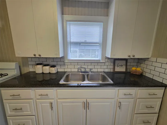 a kitchen with a sink and cabinets