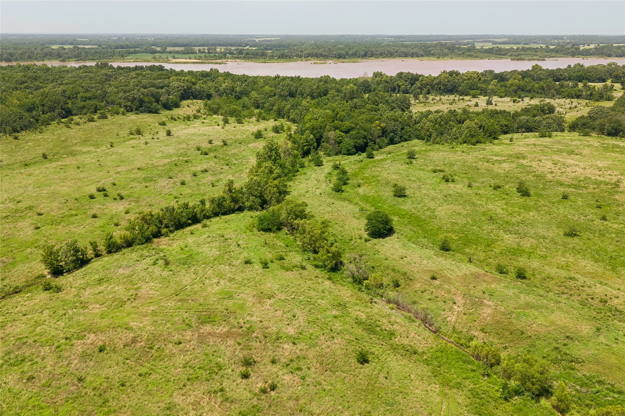 2 West Fern Mountain Road Muskogee, OK 74401 - Photo 24 of 55 Expansive green space with mature trees and a distant body of water