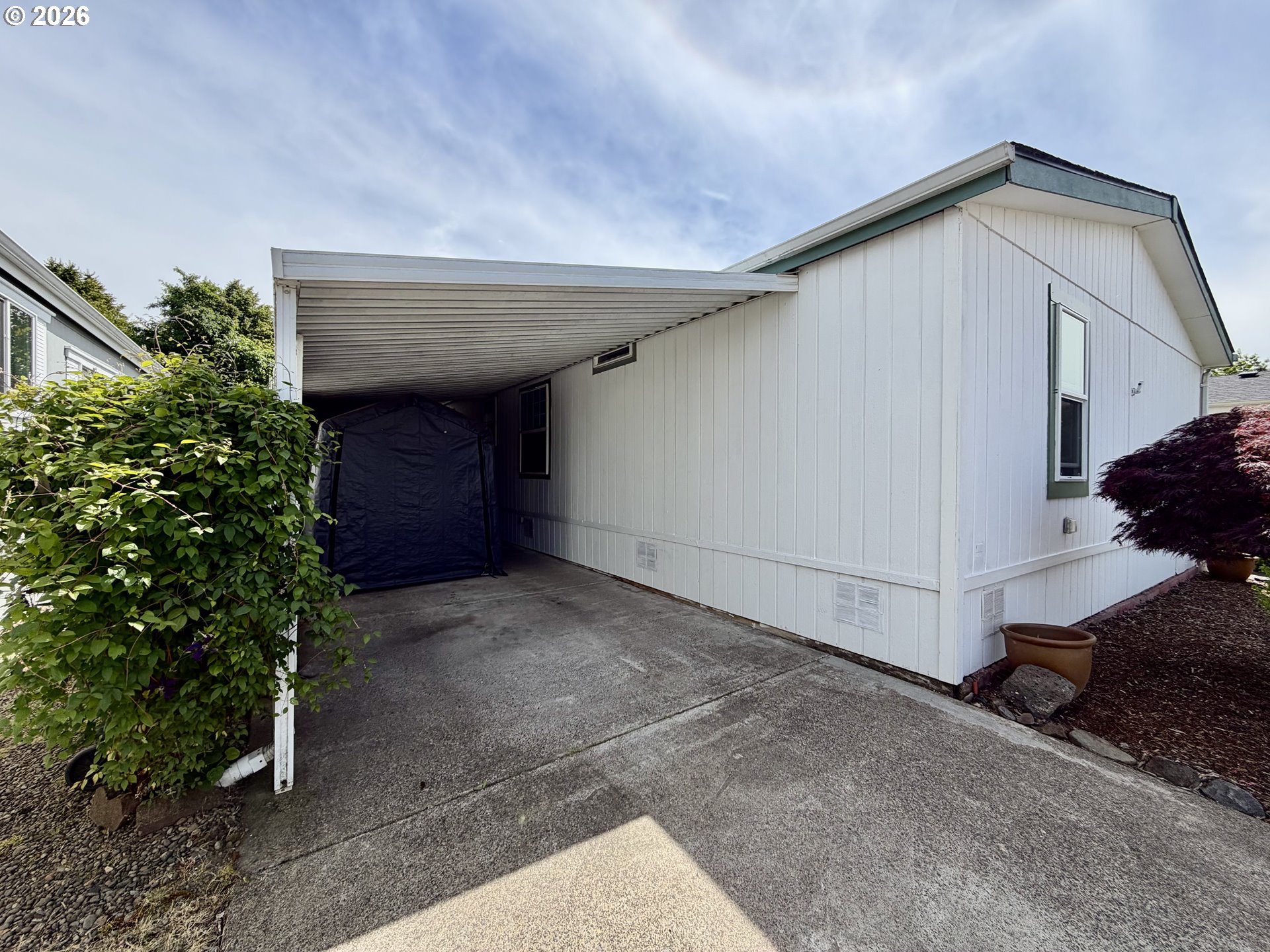 1699 North Terry Street, Unit 351 Eugene, OR 97402 - Photo 18 of 23 a view of a house with a yard and garage