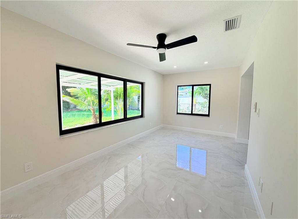 4212 32nd Avenue Southwest Naples, FL 34116 - Photo 13 of 27 a view of a livingroom with a ceiling fan and window