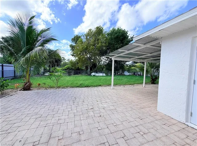 a view of a house with backyard and a garden