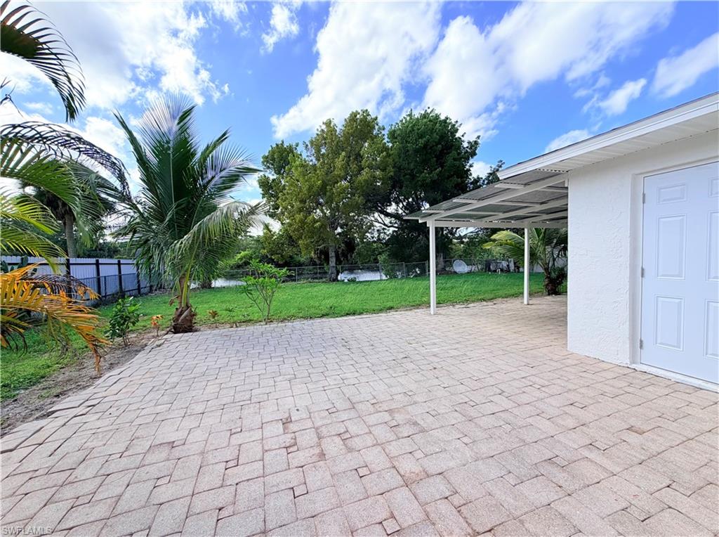 4212 32nd Avenue Southwest Naples, FL 34116 - Photo 20 of 27 a view of a house with a yard and coconut trees